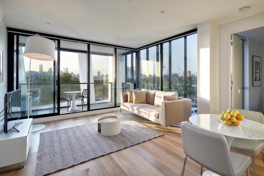 a living room filled with furniture and a large window at 381 Cremorne in Melbourne