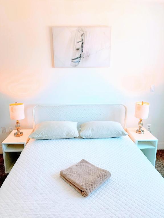 a white bed with a towel on top of it at Western Monroe in Los Angeles