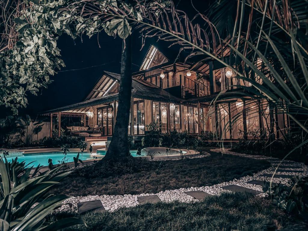 a house in a forest with a pool at night at Casa Magick boutique Villa in Gili Islands