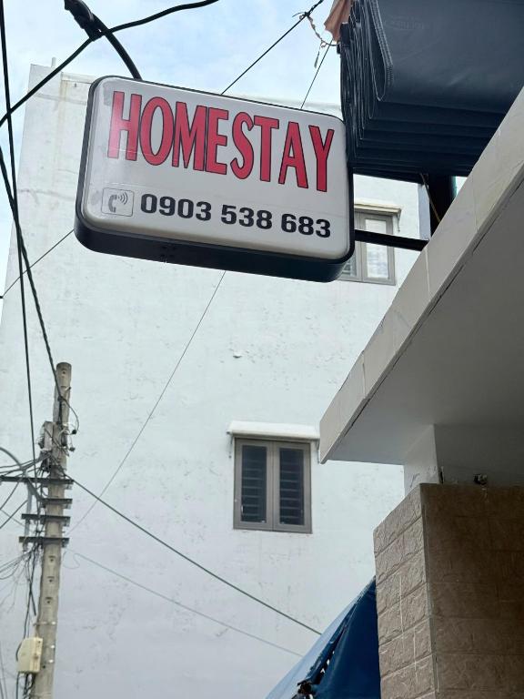 a home stay sign hanging from the side of a building at Homestay in Da Nang