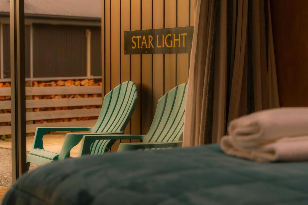 two green chairs with a sign that reads starlight at Starlight Townhouse in Twizel