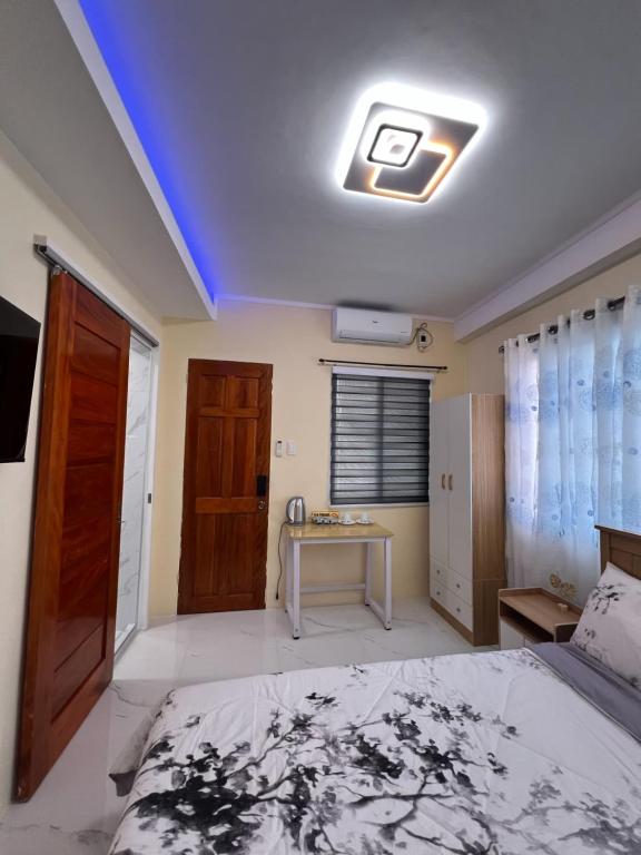 a bedroom with a bed and a table in it at Compostela Guest Room #1 Terrace, Rooftop, Netflix, WiFi in Compostela