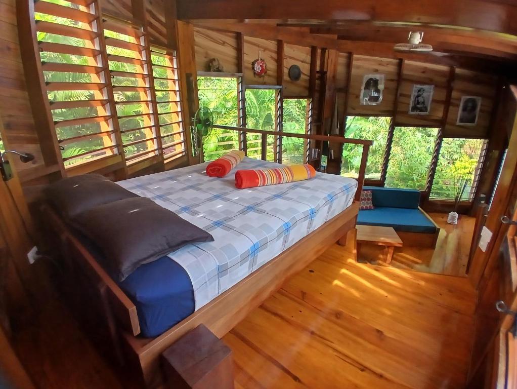 a bed in the inside of a tiny house at Shell House with Ocean View in Savusavu