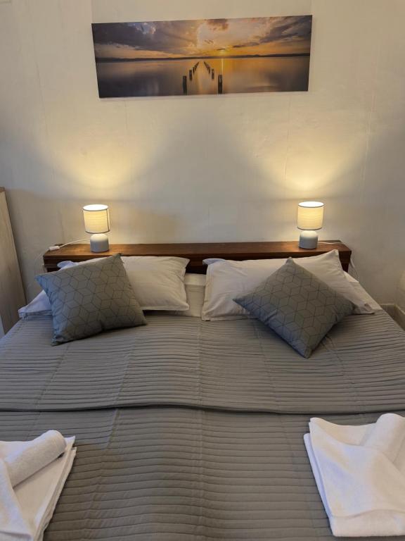 a large bed with two lamps on top of it at Studio Apartment Bella in Selca