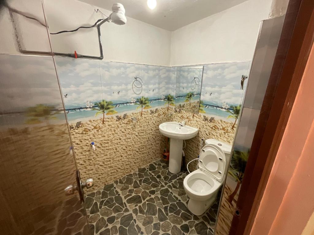 a bathroom with a toilet and a sink at Green Villa in Nuwara Eliya