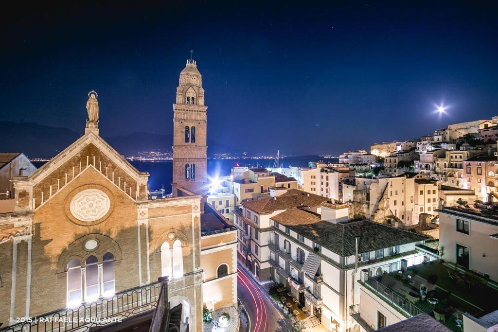 a large clock tower towering over a city at night at B&B La Gaetana in Gaeta