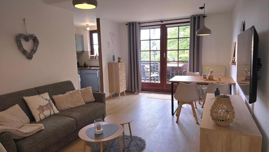 a living room with a couch and a table at Waldliebe in Bad Sachsa