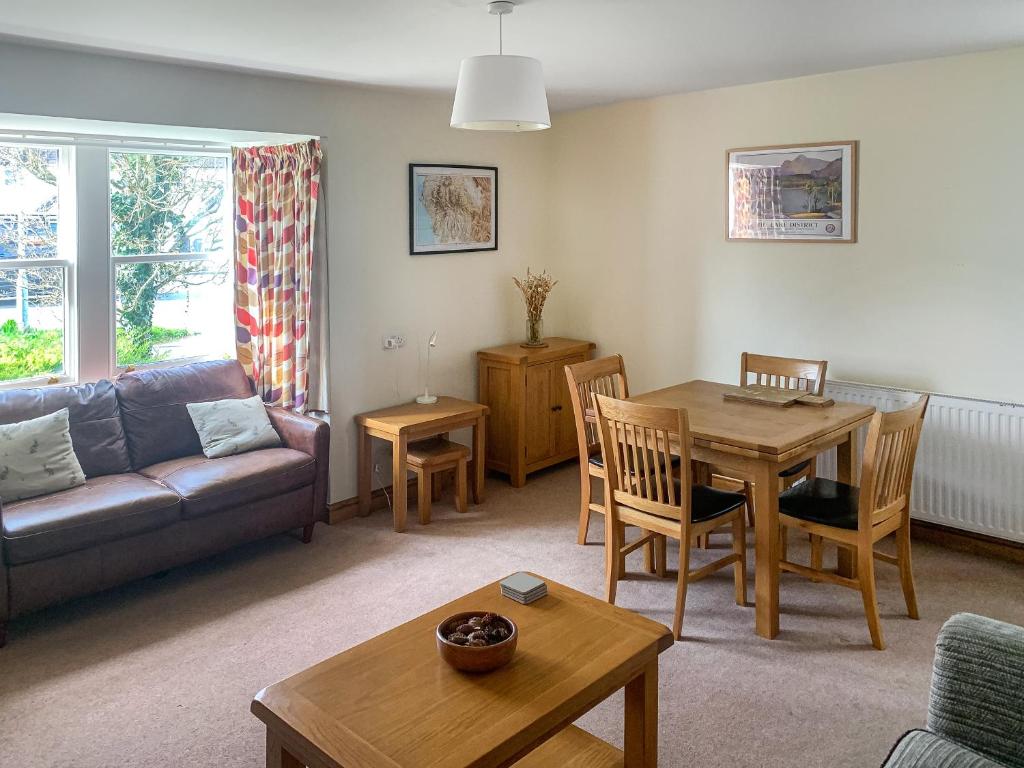 a living room with a couch and a table at 1 Lonsdale House in Keswick