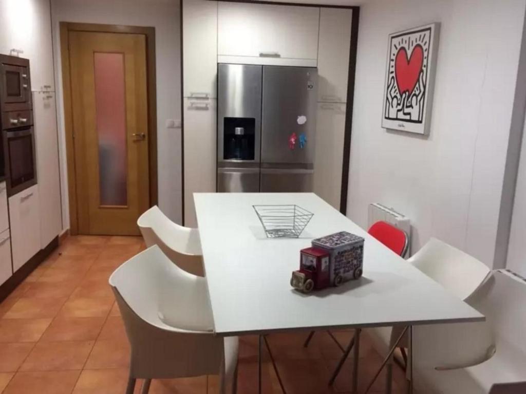 a kitchen with a white table with a toy truck on it at Apartment - 2 Bedrooms - 02447 in Malpica