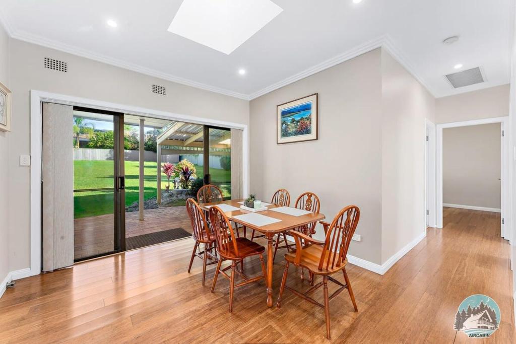 a dining room with a table and chairs at Charming 3-Bedroom House in Beacon Hill in Oxford Falls