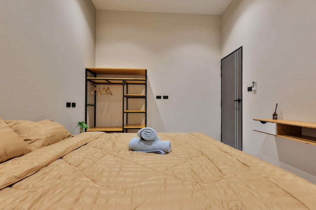 a large bed with a towel on top of it at De Helga Apartment Chaloklum in Ko Phangan