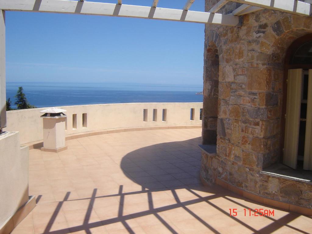 a view of a building with the ocean in the background at Villa Rotunda in Alonissos Old Town in Alonnisos