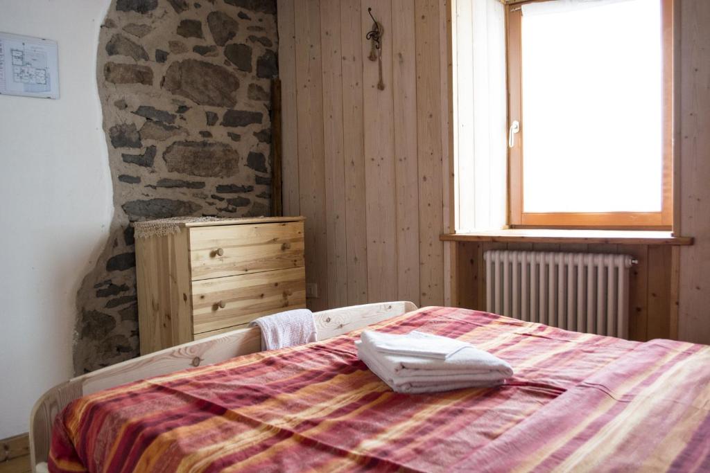 Postel nebo postele na pokoji v ubytování Rifugio Serot