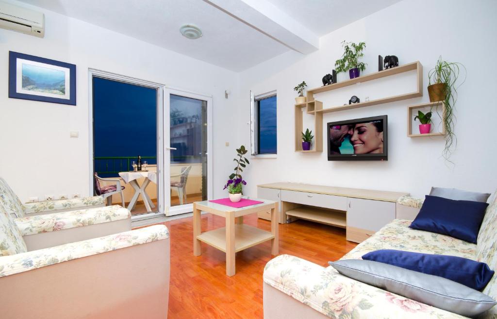 a living room with a couch and a tv at Vila Dunja in Makarska