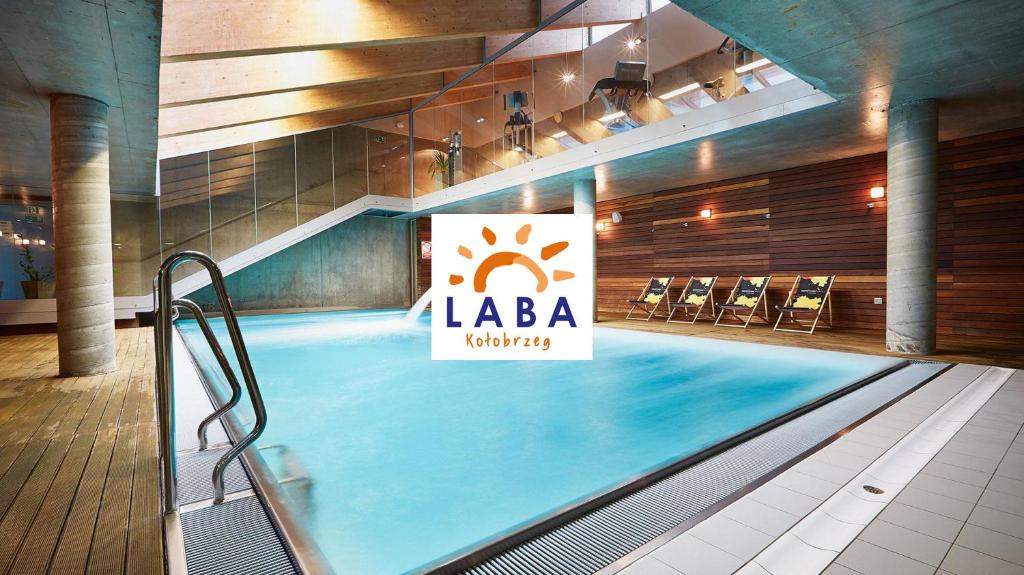 a large swimming pool with a laiba sign on it at LABA Kołobrzeg Royal Tulip Sand apartament prywatny, Basen w CENIE, Schwimmbad im PREIS in Kołobrzeg