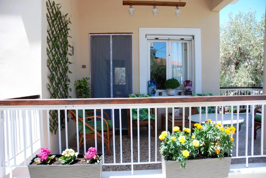 a balcony with two planters of flowers on it at Chalkida near Castle in Kánithos