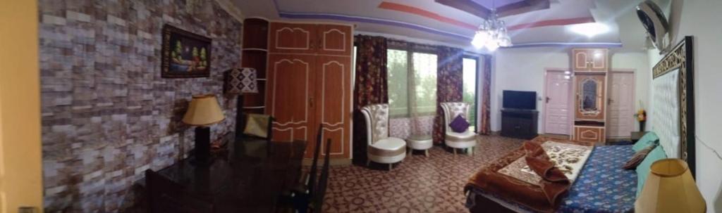 a living room with a couch and a brick wall at Executive Heights Apartments in Bhurban