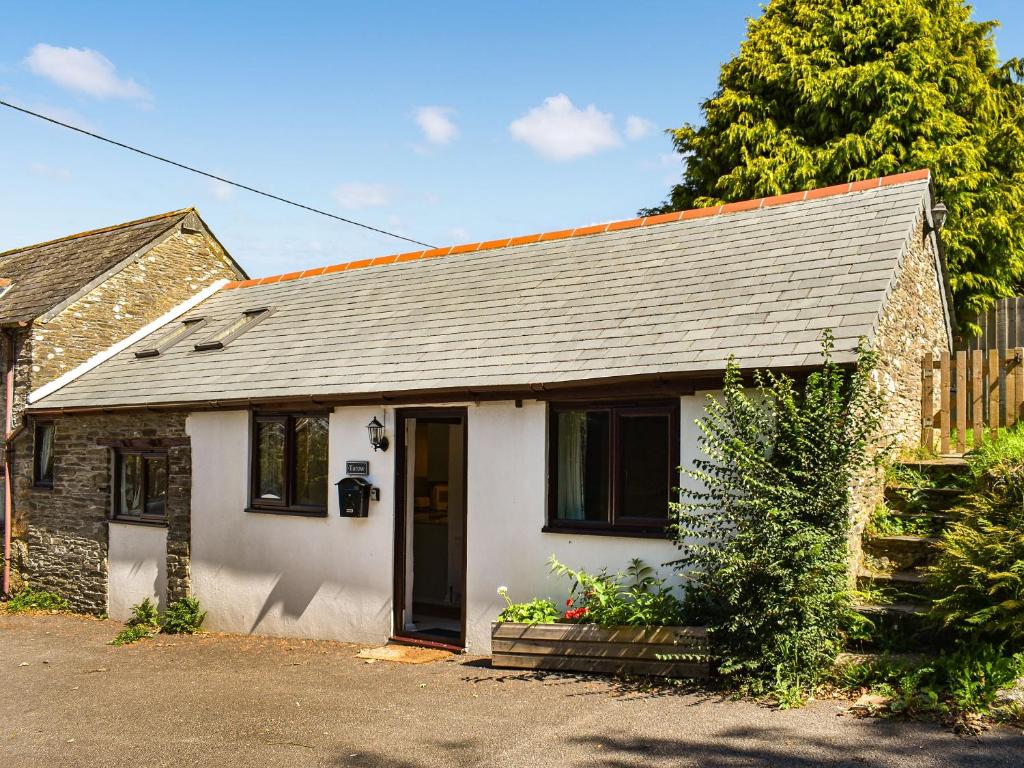 a small white house with a gray roof at Tarow Cottage in East Looe