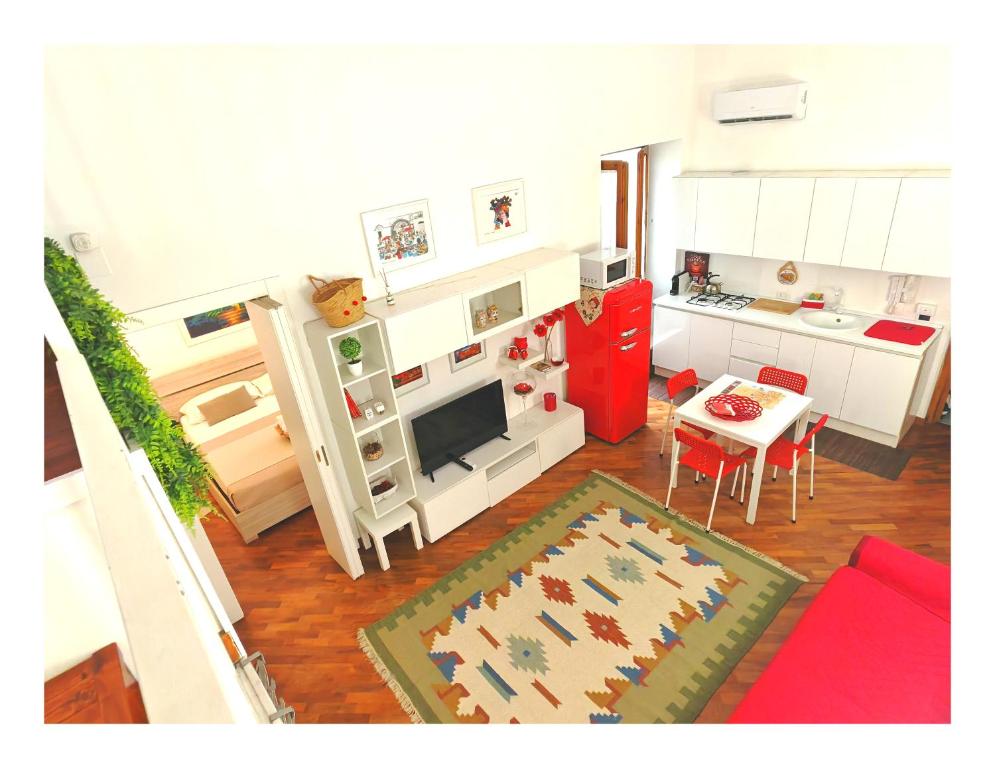 a living room with a kitchen and a table with a couch at Casa Ina Palermo in Palermo