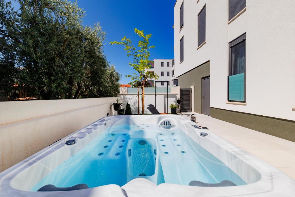 a hot tub on the roof of a house at Latitude 44 Apartment in Zadar