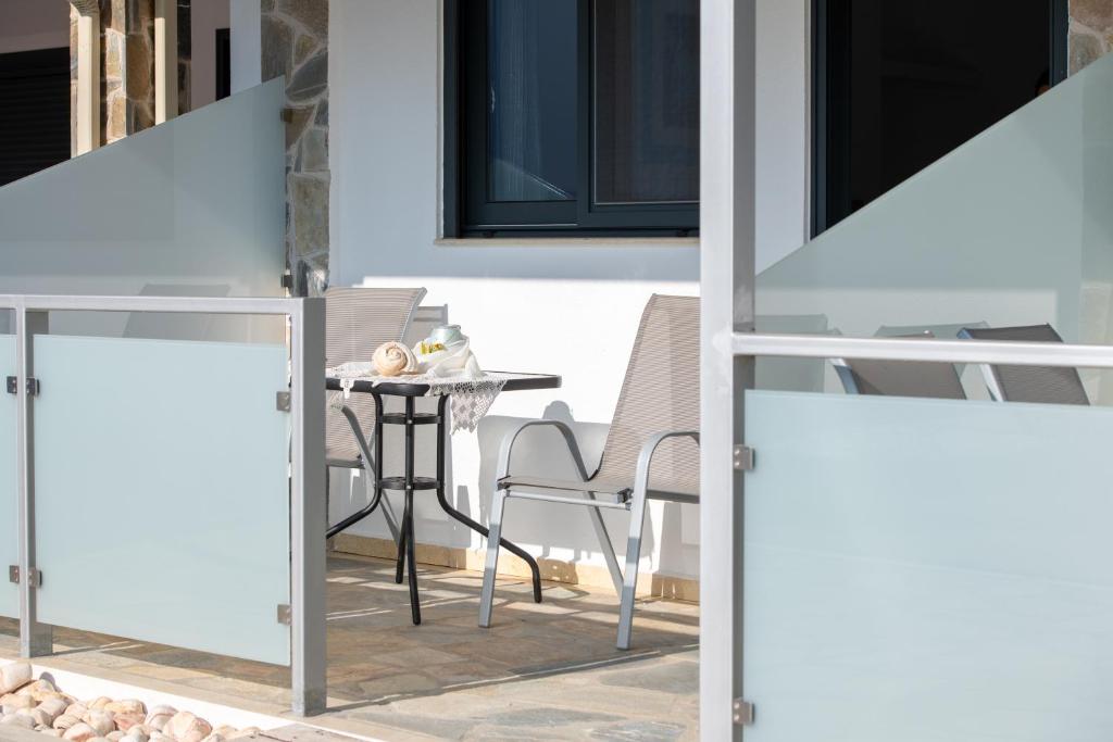 a patio with a table and chairs and a building at Maistrali Elia in Sarti