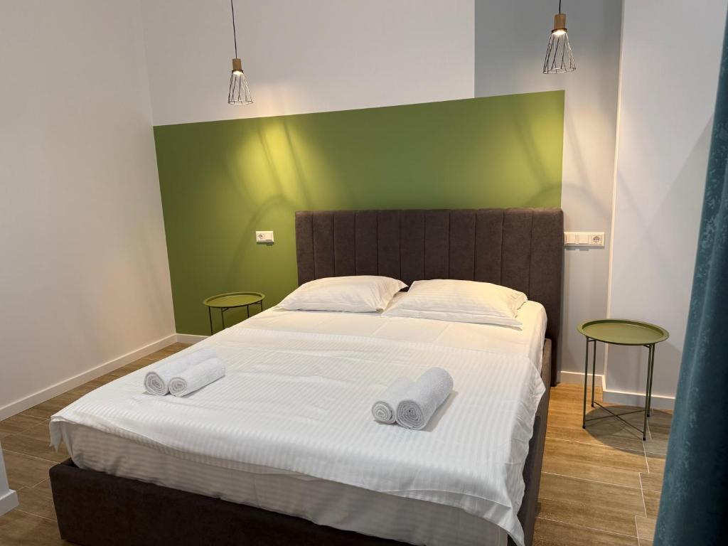 a bedroom with a bed with two towels on it at Lovely and cozy apartment! in Kutaisi