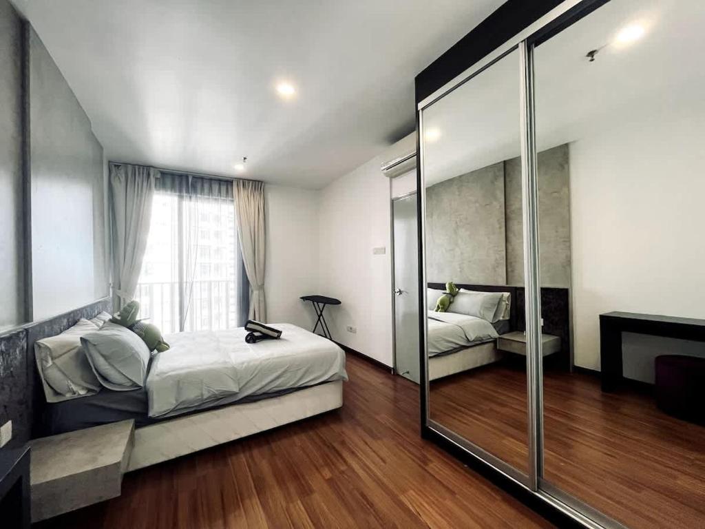 a bedroom with two beds and a mirror at Dino Homes at i-City - WiFi TV Box 1 Carpark in Shah Alam