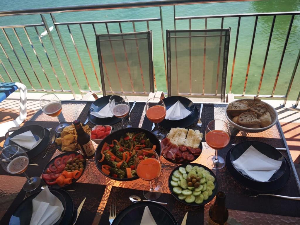 a table with plates of food and glasses of wine at Adefer Isamar in Sanxenxo