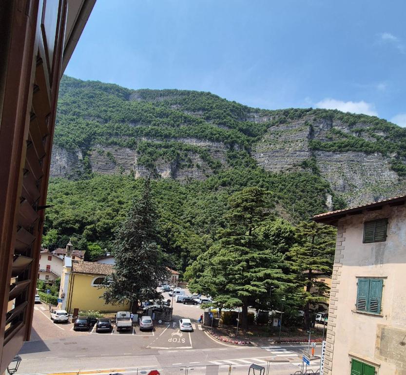 a view of a mountain with cars parked on a street at Albergo Al Borghetto in Mezzolombardo