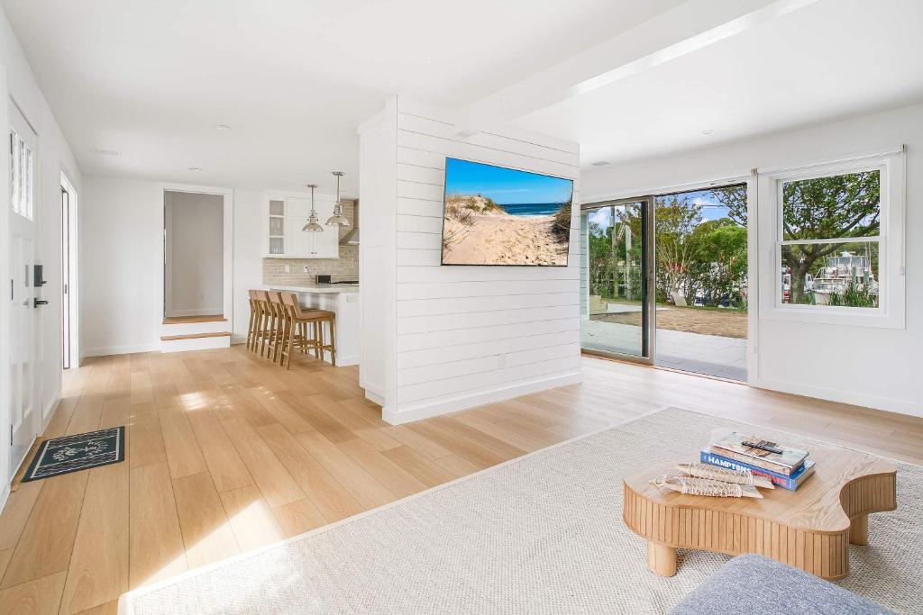 a living room with white walls and a table at Dockside 2BR - Prime Location on the Marina Unit B in Montauk