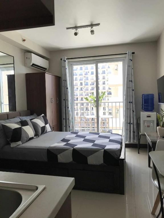 Ένα ή περισσότερα κρεβάτια σε δωμάτιο στο Staycation