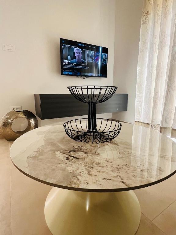 a glass table in a living room with a tv at Apartmani Leon in Međugorje
