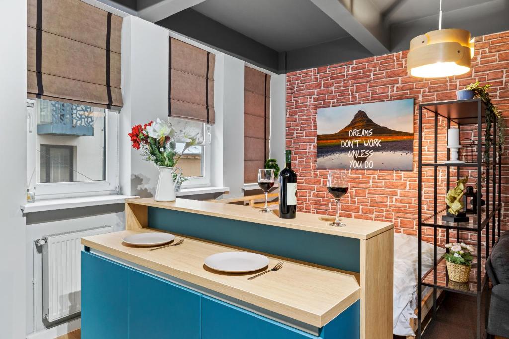 a dining room with a brick wall and a blue counter at Old Town Smârdan Studios - Central Lively Area in Bucharest