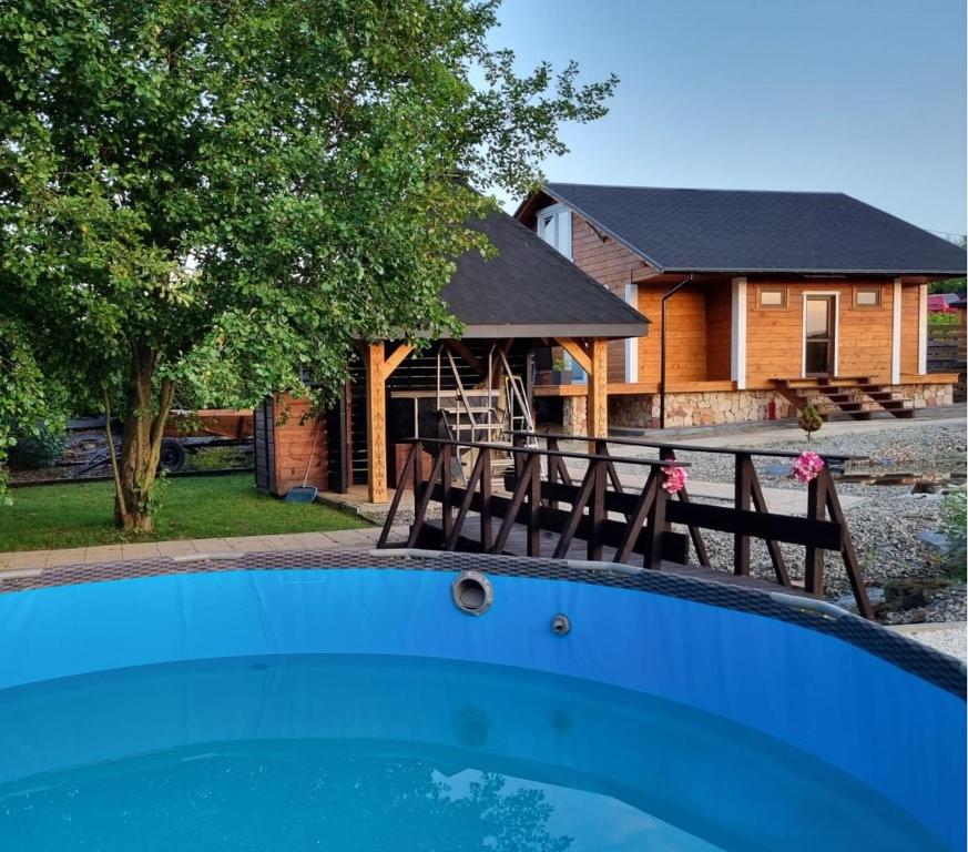 a house with a swimming pool in front of a house at Villa SPA 