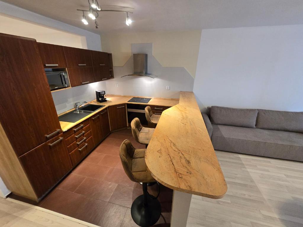 a kitchen with a wooden table in a room at Apartment Vodni with parking in Brno