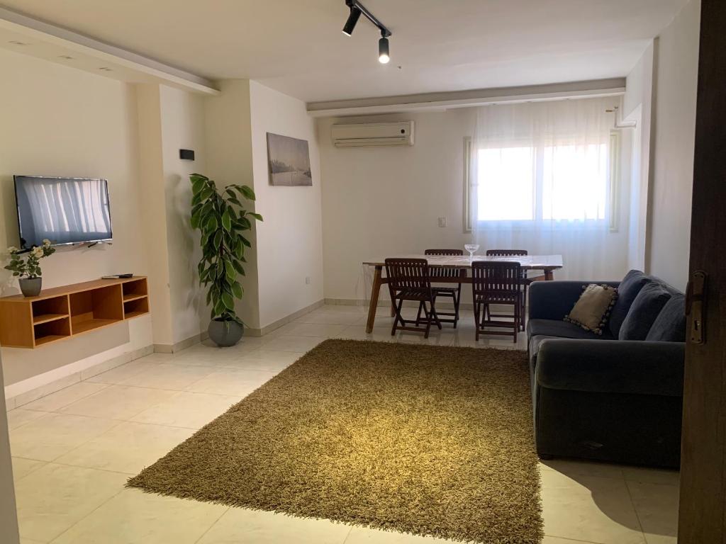 a living room with a couch and a table at New cozy apartment 10 minutes away from Cairo airport in Cairo