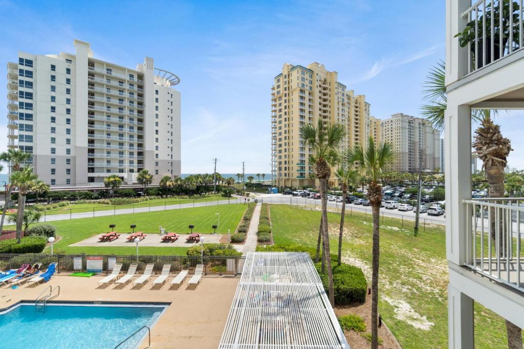 a view from the balcony of a apartment with a pool and buildings at GULF VIEW condo King bed with bunk and LARGE L shaped balcony in cozy Perdido Key in Pensacola