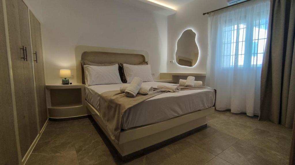 a bedroom with a large bed with white sheets and pillows at Marina's House in Kinídharos