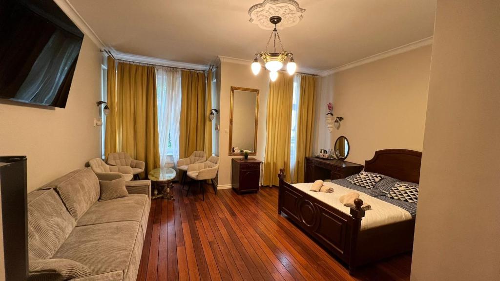 a living room with a bed and a couch at Pokoje Sopot Rooms in Sopot