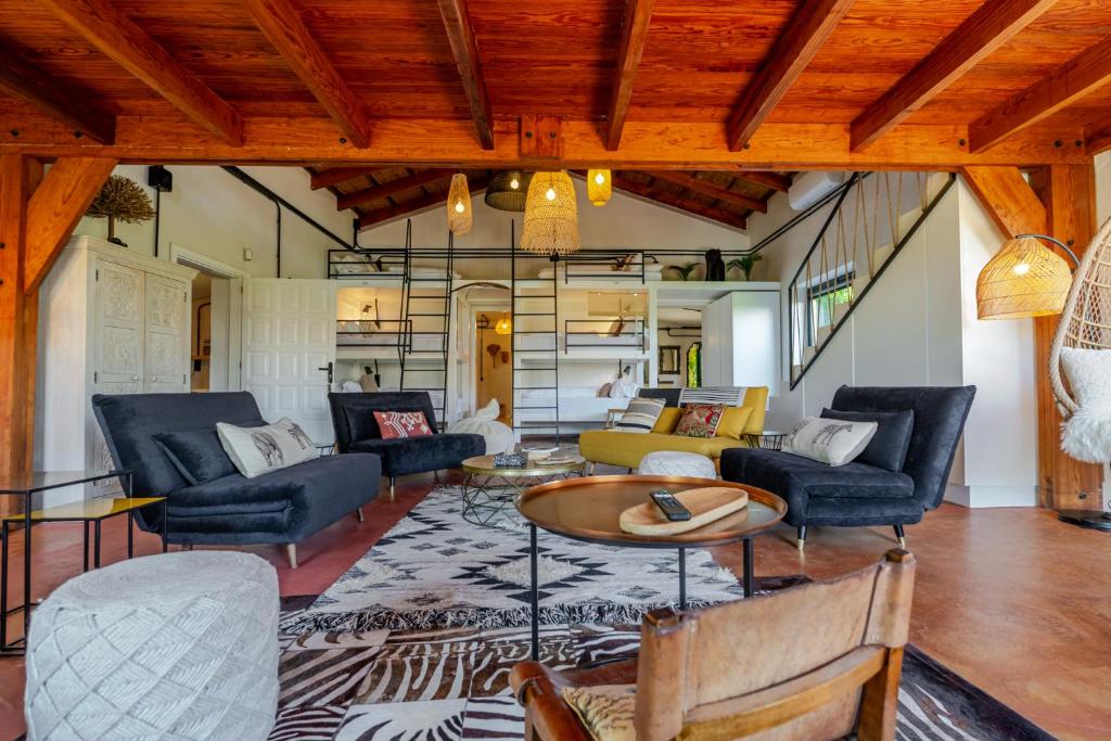 a living room filled with furniture and a wooden ceiling at Karibu Lodge Boutique in Vega de San Mateo