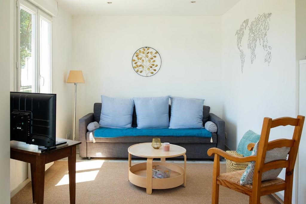 a living room with a couch and a table at La Casinière Coëtquidan in Guer