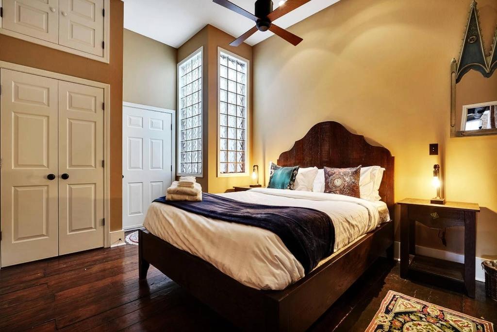 a bedroom with a large bed with a ceiling fan at Chic Loft | Downtown | Front & Market in Wilmington