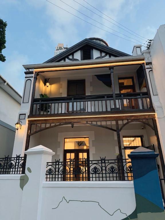 a large white house with a balcony at Three Anchor Heart in Cape Town