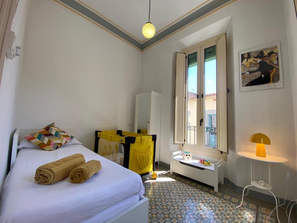 a bedroom with two beds and a window at Casa Estela Agullana in Agullana