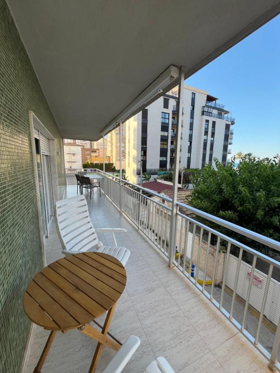 a balcony with a wooden table and chairs on it at Bacarola in Los Mártires