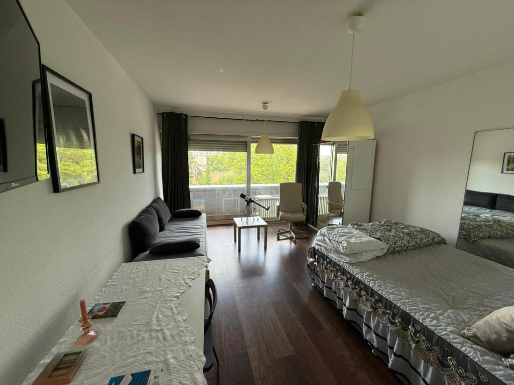 a living room with a bed and a couch at Chic Central Stay in Luxembourg in Luxembourg