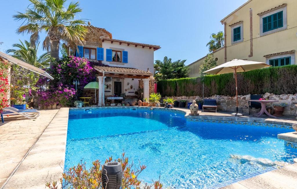 a swimming pool in front of a house at Sa Torre in Cala Santanyi