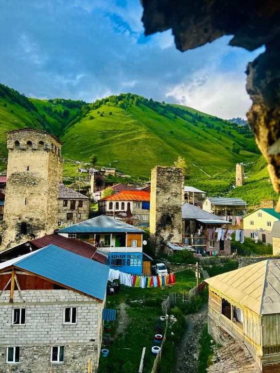 a small town with a mountain in the background at Bata GuesThouse in Adishi