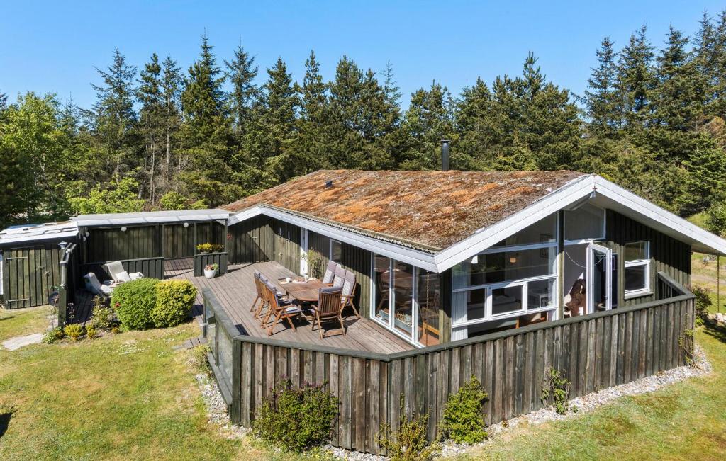 a house with a deck and a roof at 3 Bedroom Stunning Home In Blokhus in Blokhus