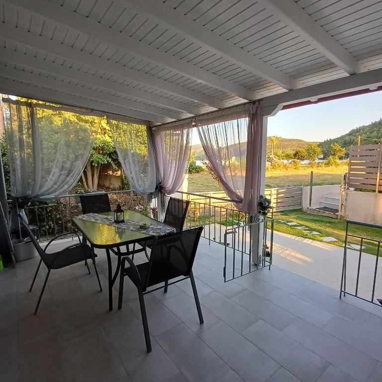 a patio with a table and chairs on it at Casa Chinook Sea View Homes-Porto Koufo in Porto Koufo
